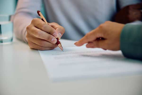man signing contract
