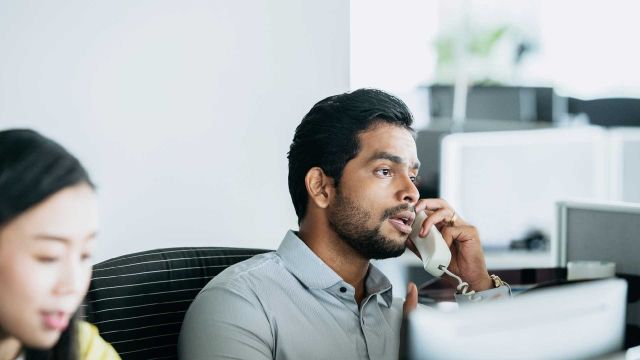 Man on a landline phone